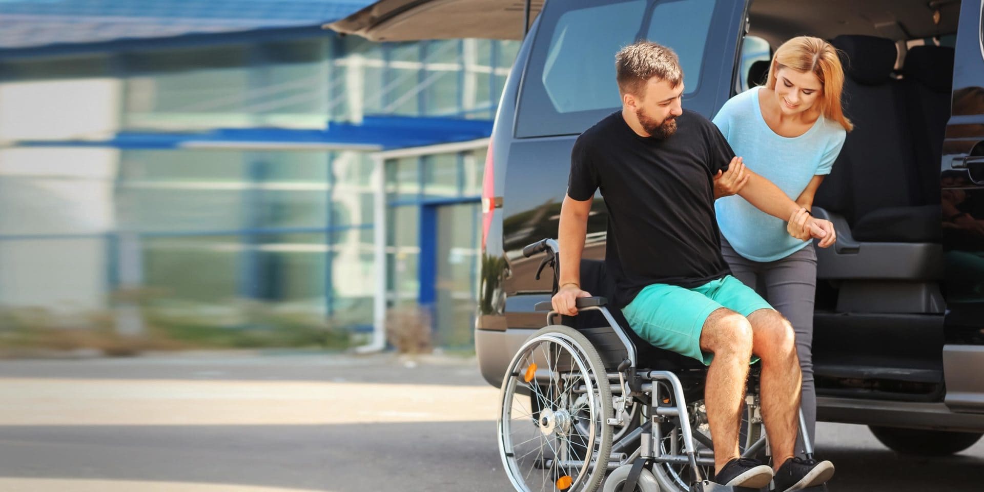Medical transport driver helping patient into vehicle