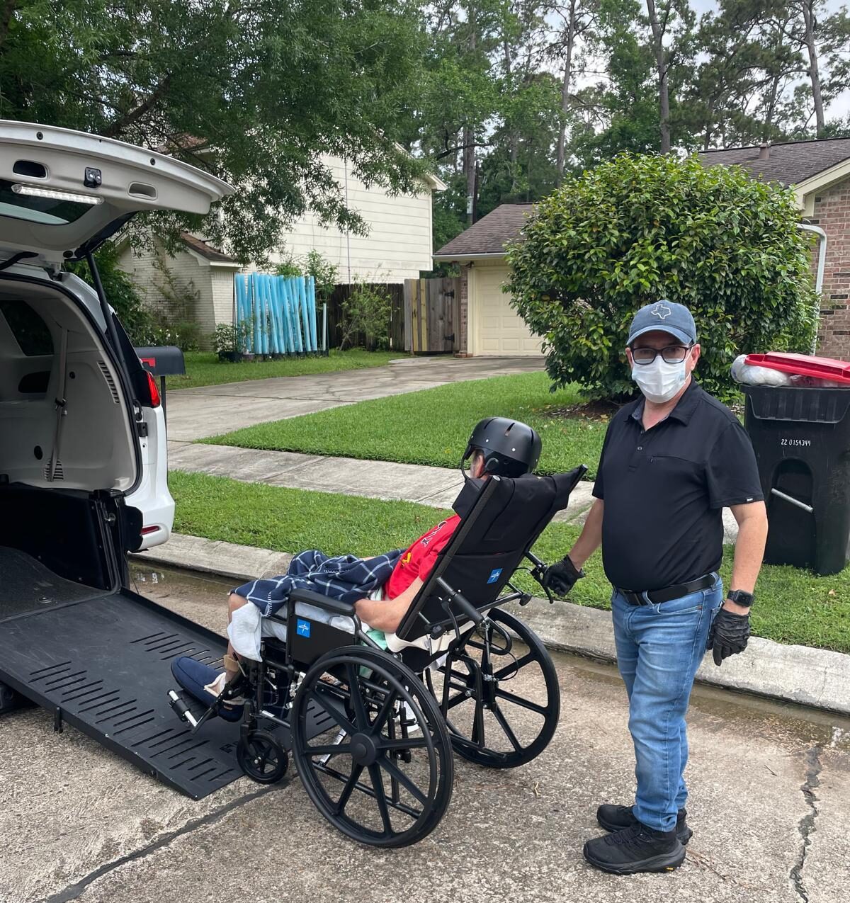 NEMT driver assisting patient at home pickup - door-to-door service