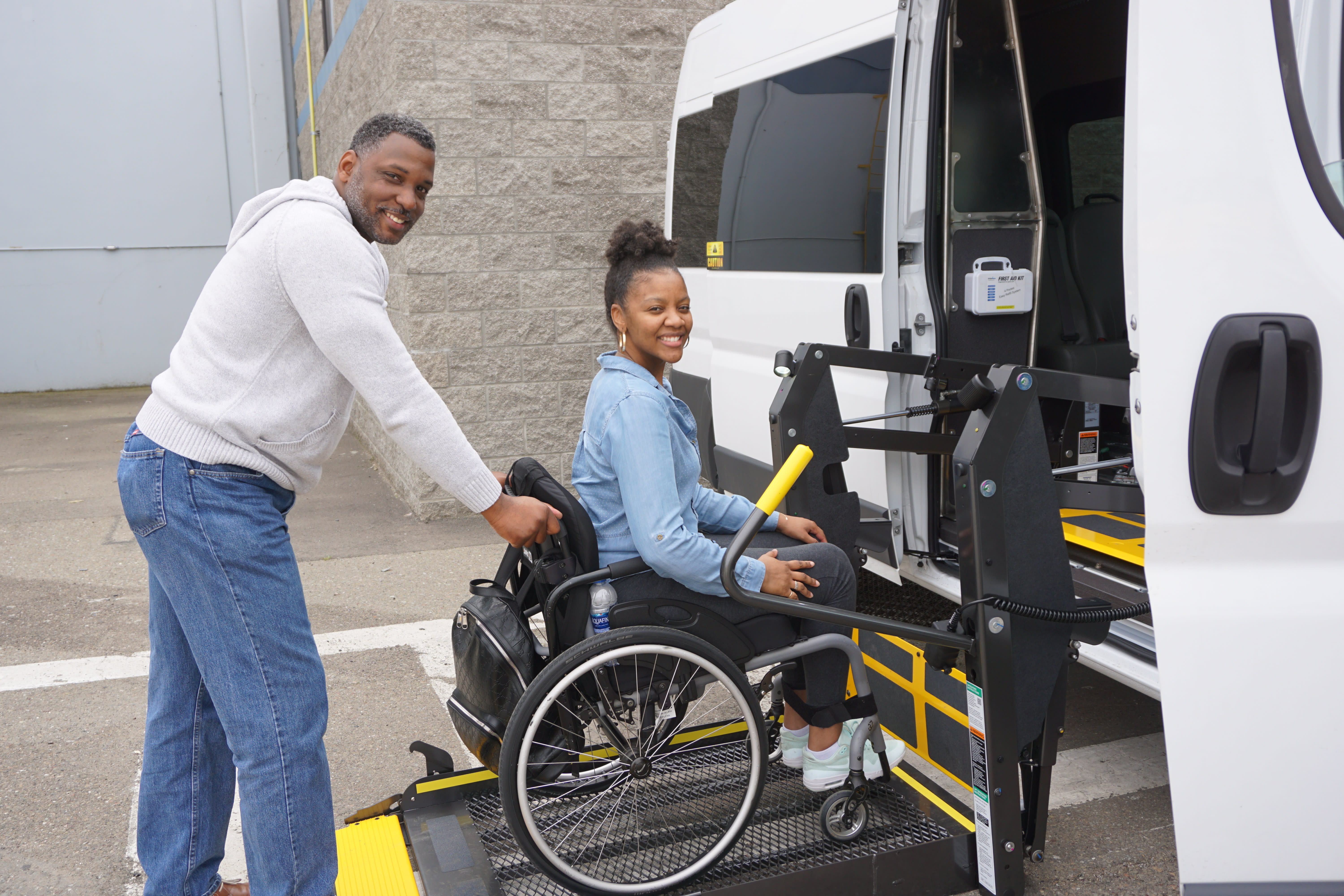 Crown Care NEMT driver assisting a wheelchair patient onto an accessible van lift